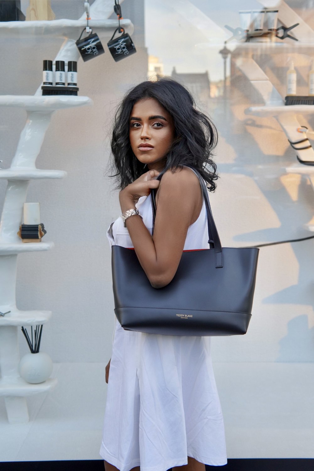 Sachini wearing a Teddy Blake bag 