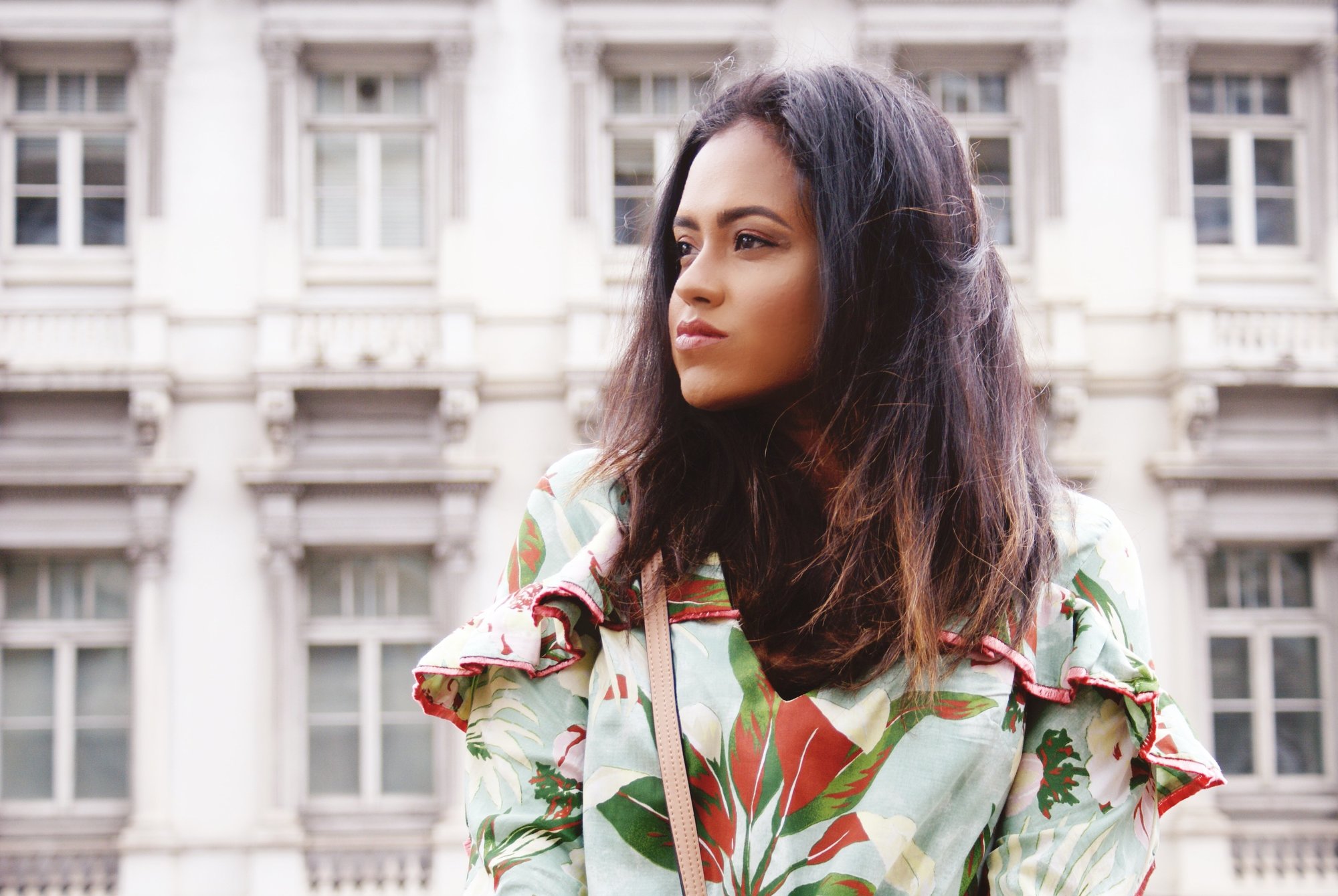 Close up of Sachini wearing a floral top