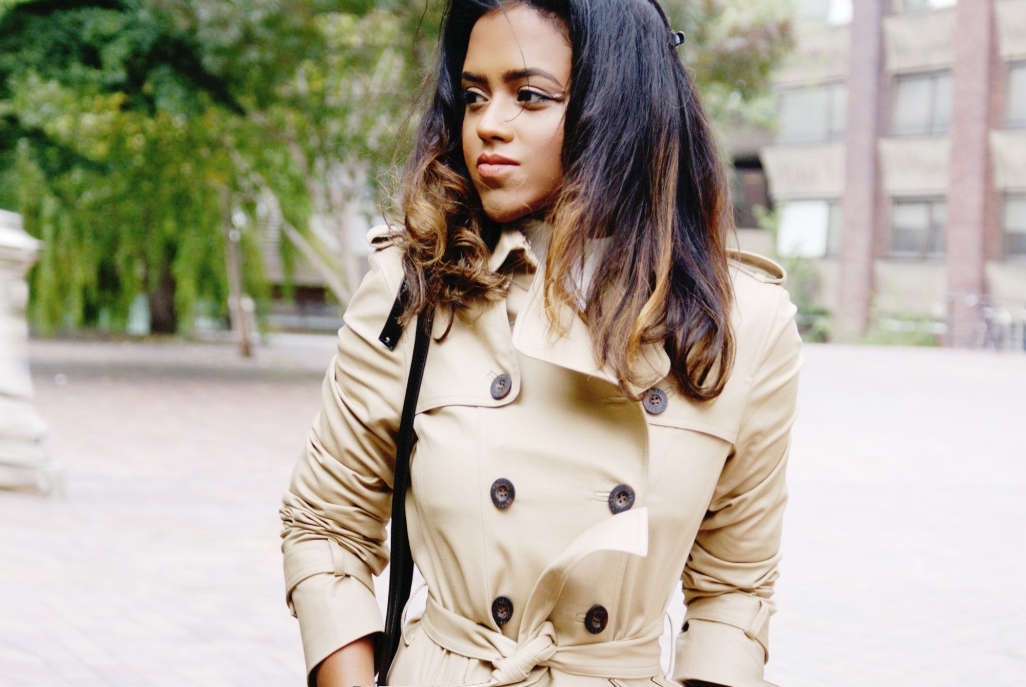 Sachini wearing a brown trench coat