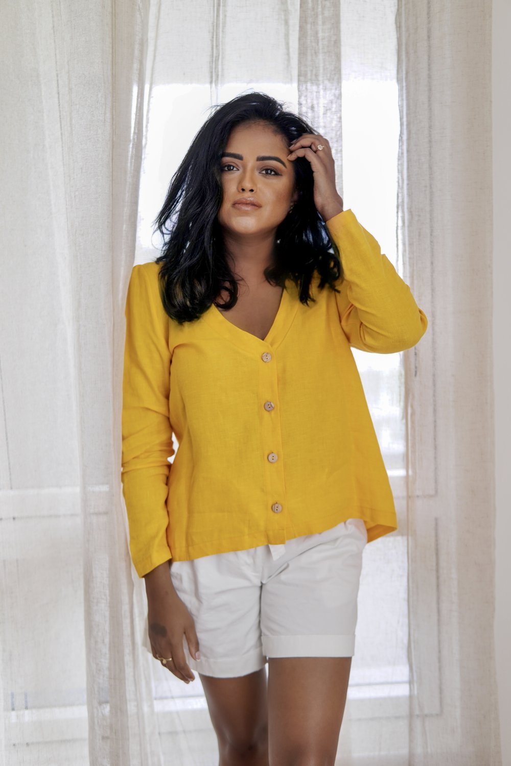 Sachini wearing a yellow linen shirt